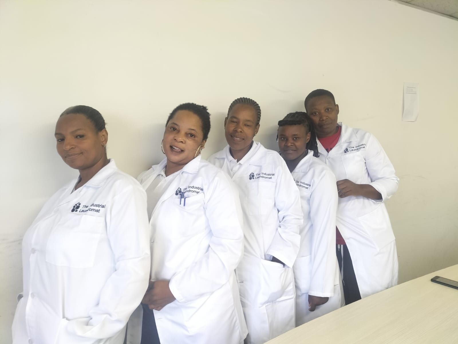 Industrial Laundromat team in branded uniforms